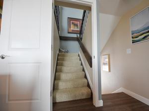 a staircase in a home with a stair case at Meadowridge Court 19 Unit 1 in Fraser