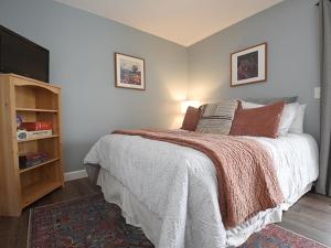 a bedroom with a bed and a television in it at Meadowridge Court 19 Unit 1 in Fraser