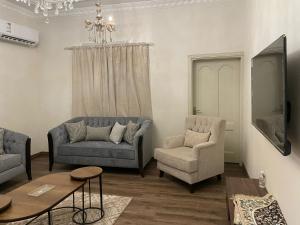 a living room with two couches and a table at شقق مفروشه للايجار اليومي بالطائف in Al Ḩawīyah