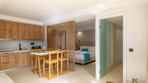 a kitchen and living room with a bed and a table at D PALM Premium Living - Kalathas, Chania in Chania Town