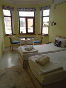 Ένα ή περισσότερα κρεβάτια σε δωμάτιο στο Hotel Dilnura