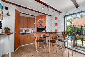 a kitchen with a table and chairs in a room at Villa ZaVaLa Brzac in Brzac