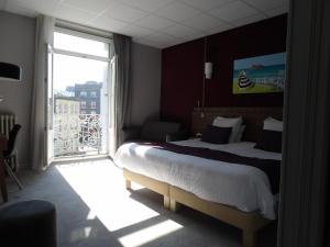 a hotel room with a bed and a large window at Best Western Le Duguesclin Hôtel-Restaurant in Saint-Brieuc