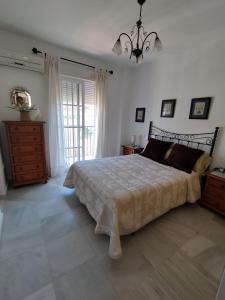 a bedroom with a bed and a dresser and a window at Apartamento Plaza Nueva del Morche in Morche