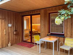 a room with a table and chairs on a deck at Stadtfüchse plus Sauna in Bad Ischl