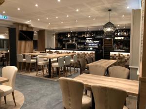 a restaurant with tables and chairs and a bar at Best Western Le Duguesclin Hôtel-Restaurant in Saint-Brieuc