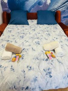 a bed with a blue and white comforter on it at Cosy Appart - Plage à 2min - Casino à 1min in Trouville-sur-Mer