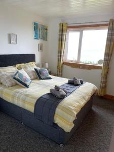 a bedroom with a large bed with towels on it at The Stroops in Helmsdale