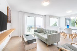 a living room with a couch and a table at Villa Enderrossall in Porto Cristo