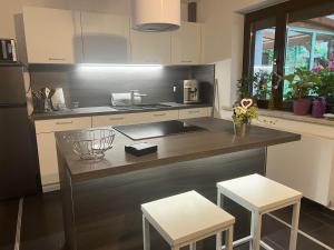 a kitchen with a counter with two stools in it at Ferien47 Pirna in Pirna