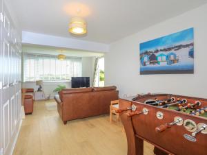 a living room with a couch and a pool table at Mor Glas in Abersoch