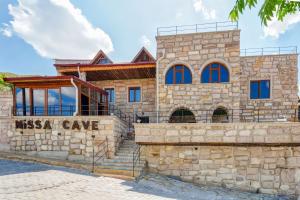 a stone building with a sign in front of it at Nissa Cave in Göreme