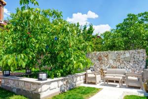 a garden with chairs and a stone wall at Nissa Cave in Göreme +9 photos