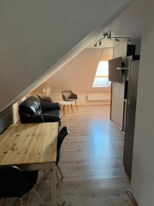 a living room with a couch and a table at Apartman Na Bubnu in Náchod +8 photos