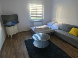 a living room with a couch and a coffee table at Pod Wieżą in Wałbrzych