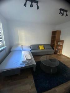 a bedroom with a bed and a coffee table at Pod Wieżą in Wałbrzych