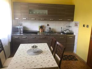 a kitchen with a table and chairs and a kitchen with a table and a kitchen at Juhas in Zwardoń