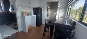 a small kitchen with a counter and a black refrigerator at TBJ HOMESTAy in Wakaf Baharu +4 photos