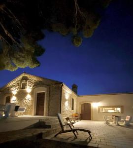 a bench sitting in front of a building at night at Le Tre Lune B&B in Lucera