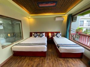 Postel nebo postele na pokoji v ubytování Botanic Sapa Hotel