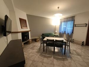a living room with a table and chairs and a couch at Chez Maison Grande in Aosta