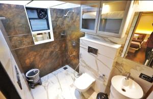 a small bathroom with a toilet and a sink at Classic Premium luxurious 3bhk fully furnished apartment in koregaon park in Pune +23 photos