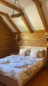 a bedroom with a large bed with wooden walls at Villa Breza in Žabljak