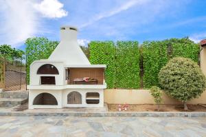 a dog house sitting on a patio next to a fence at Anastasia Veranna Villa in Lachania