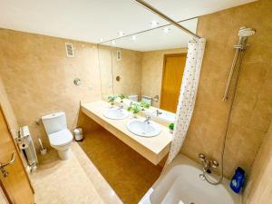 a bathroom with two sinks and a shower at Bielsa del Pilar Turistea in Zaragoza +34 photos