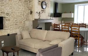 a living room with a couch and a dining room at Maison charmante aux Riceys avec cour extérieure in Les Riceys