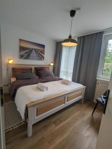 a bedroom with a large bed and a large window at ALLROOM Modernes Apartment in Unterschleißheim Nur 20 Minuten nach München in Unterschleißheim