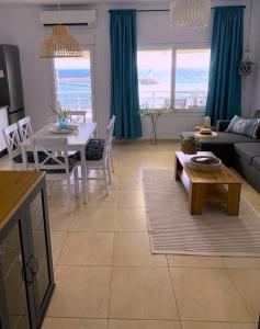 a living room with a couch and a table at Kima Sea Apartment in Nikiti +31 photos