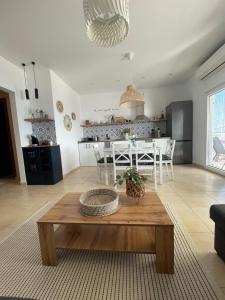 a living room with a table and a kitchen at Kima Sea Apartment in Nikiti