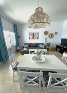 a living room with a white table and chairs at Kima Sea Apartment in Nikiti