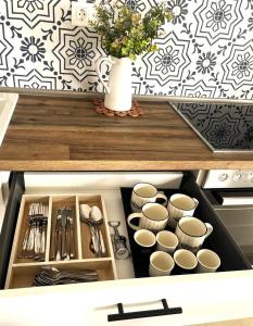 a cabinet with dishes and a vase on top of it at Kima Sea Apartment in Nikiti
