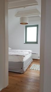 a bedroom with a bed and a window at Grand Cru 4 Vendégház in Hegymagas