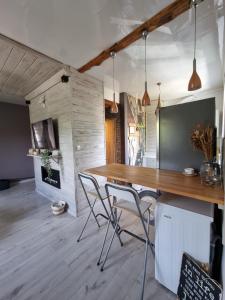 a dining room with a wooden table and chairs at Boho Jura in Zawiercie