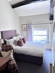 a bedroom with a large bed and a window at Plato's in Kirkby Lonsdale