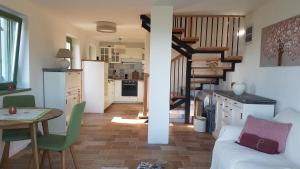 a kitchen and a living room with a spiral staircase at Grand Cru 4 Vendégház in Hegymagas +11 photos