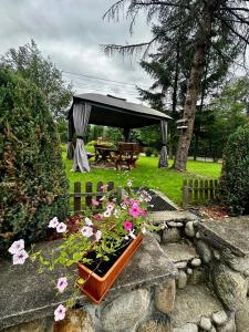 a garden with a gazebo and some flowers at LookTatry Willa Pod Stokiem Apartments & Jacuzzi in Zakopane +278 photos