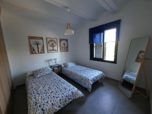 a bedroom with two beds and a window at Villa Las Encinas in Guillena +15 photos