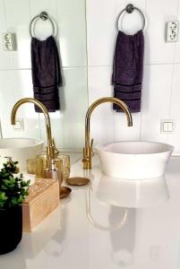 a bathroom with two sinks and two faucets at Wanha Neuvola Guesthouse in Pieksämäki +32 photos