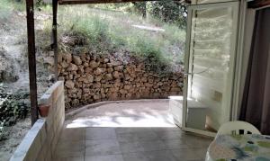 a room with a stone wall next to a patio at Cabanon 50m2 in Méounes-lès-Montrieux +2 photos