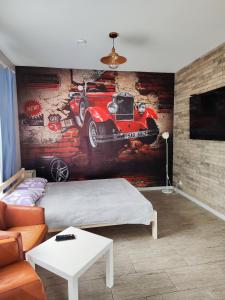 a bedroom with a painting of a car on the wall at Apartment jacuzzi RR terrace in Vilnius +9 photos
