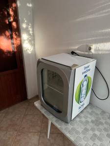 a microwave sitting on a table with a box on it at Apartmani Rakić in Ulcinj
