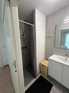 a bathroom with a shower and a sink at Appartement AN-Lux in Saint-Louis +41 photos