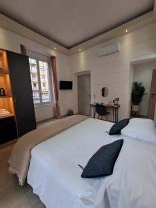 a large white bed in a bedroom with a window at La Siesta 5 terre in La Spezia
