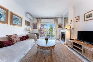 a living room with a couch and a coffee table at Lovely apartment in peaceful area in Mijas