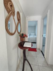 a room with a table with a book and a bed at Ecomar Pousada in São José da Coroa Grande