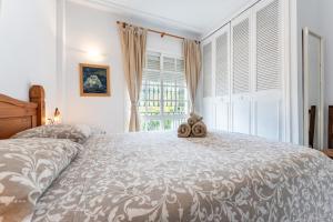 a bedroom with a bed with a teddy bear on it at Lovely apartment in peaceful area in Mijas +13 photos